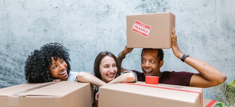 Movers helping prepare moving boxes