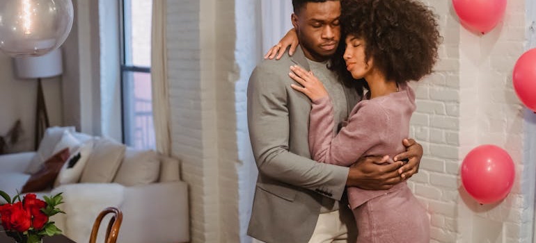 A couple dancing in a living room decorated for Valentine’s Day