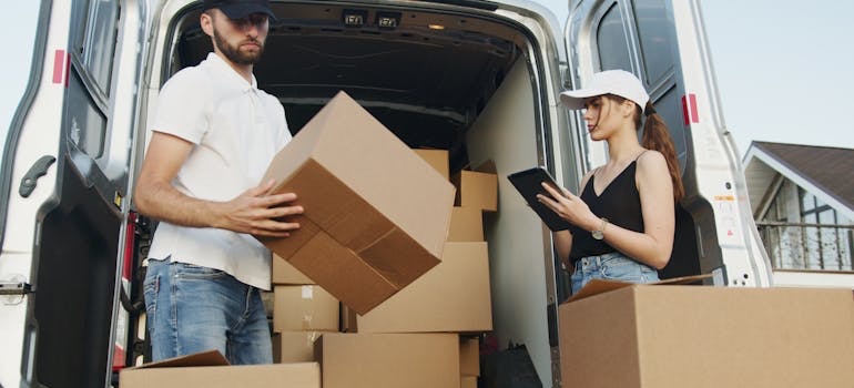 Movers loading boxes into a moving van