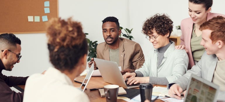 Coworkers meeting around a table in an office