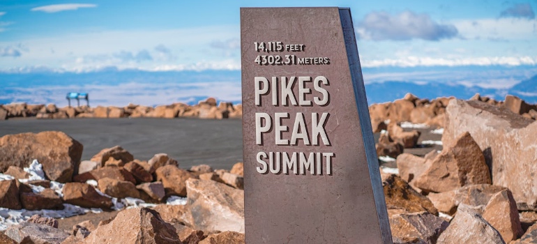Pikes Peak summit marker, one of the top natural attractions to visit after moving to Colorado