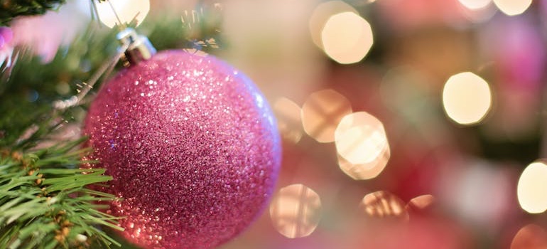 A Christmas ornament hanging from a decorated tree