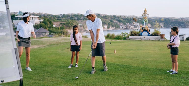 A family playing golf in Thornton, one of the quieter Colorado places to move