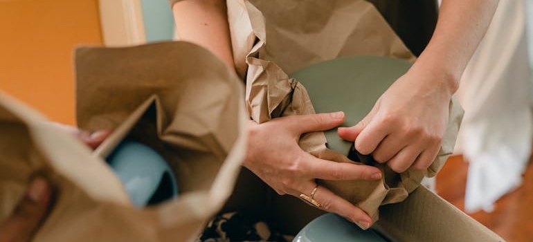 People packing their belongings into boxes to avoid damage while moving