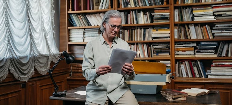 Older man reading a book at home