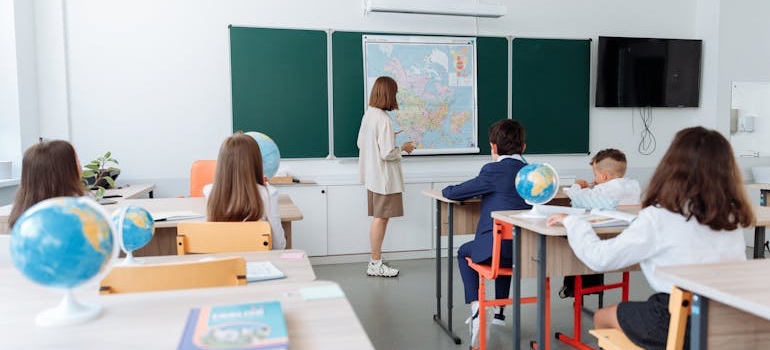 Children raising hands in a classroom