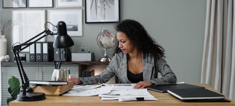 A person reviewing tax paperwork and receipts to plan relocation tax strategies for a Colorado move