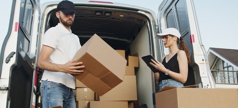 Movers packing boxes into a van