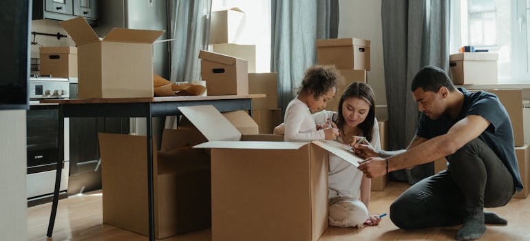 A couple unpacking moving boxes in their new home
