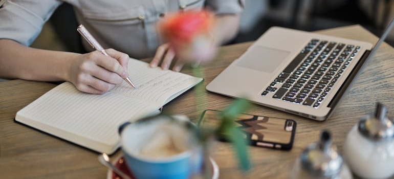 A person writing a list in a notebook