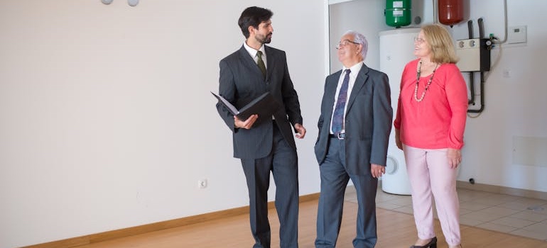 A real estate agent showing a couple a home
