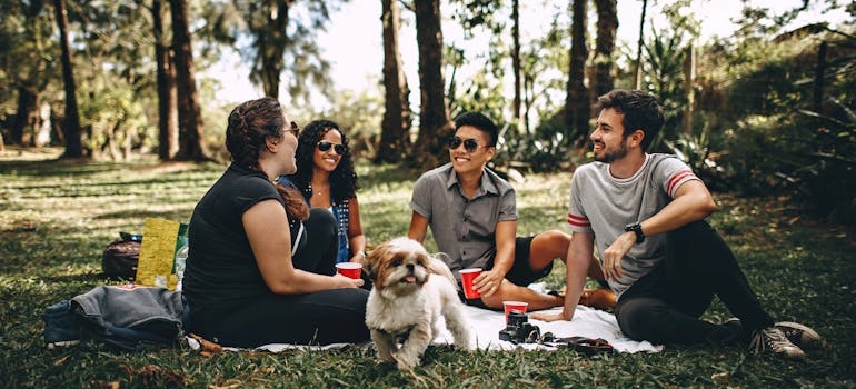 Friends sitting together in a park on a sunny day