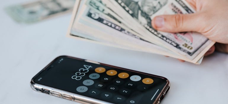 A person reviewing bills and a calculator while budgeting