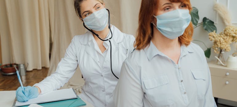 A doctor talking with a patient in an exam room