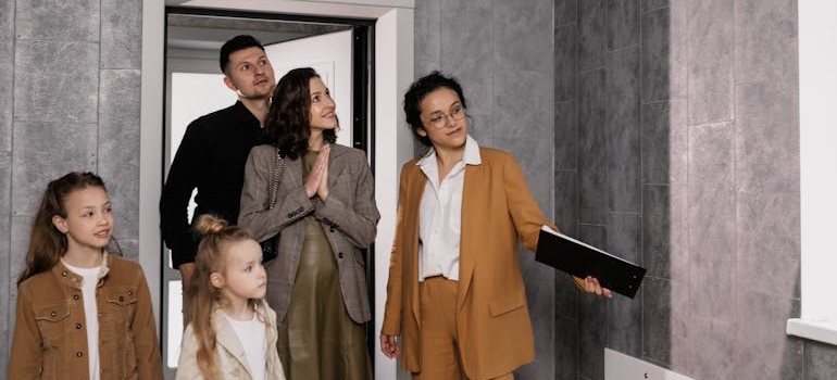 A real estate agent showing people a home before moving to Oxford with your family