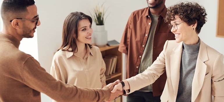 People shaking hands at a meeting