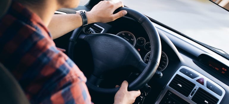 A person driving a car after choosing a Denver neighborhood based on your commute