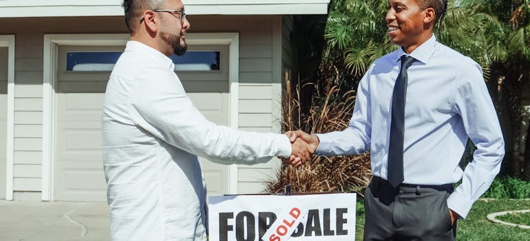 A real estate agent shaking hands with a client after a Memphis home sale