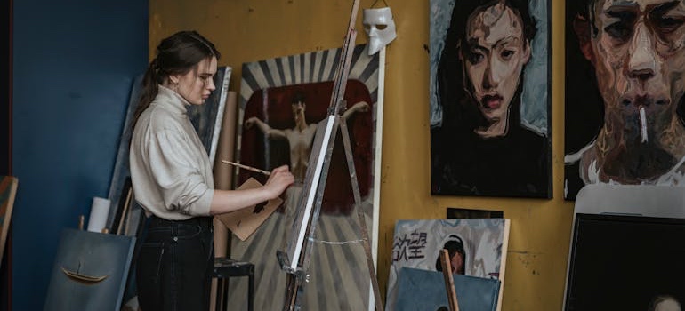 An artist painting after moving to one of the top artistic communities in Colorado