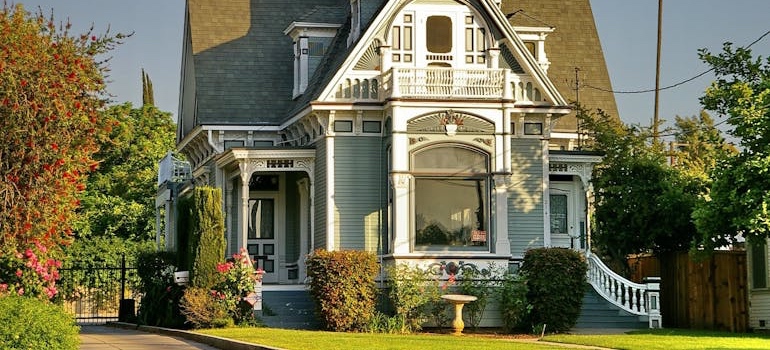 The exterior of a historic brick home with a front porch