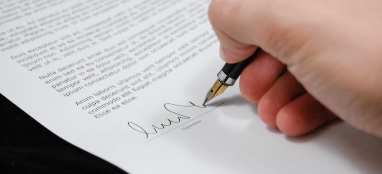 A person signing a permit application for a historic home renovation