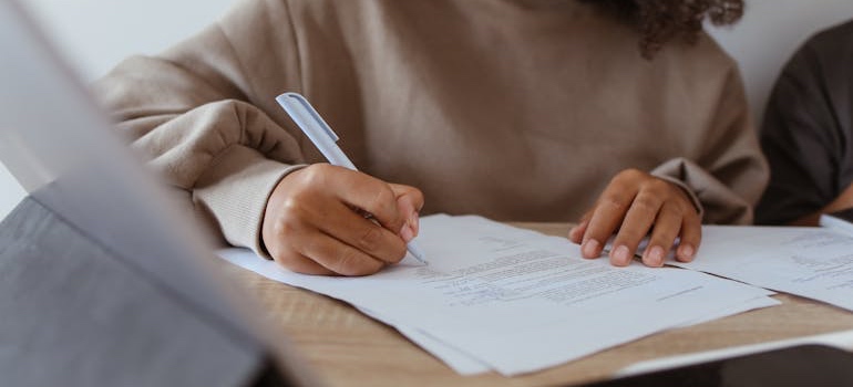 A person filling out a grant application in one of the top artistic communities in Colorado