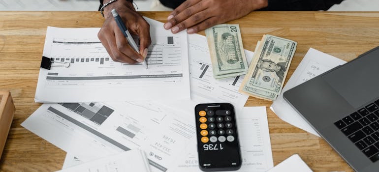 A person budgeting with a calculator and receipts