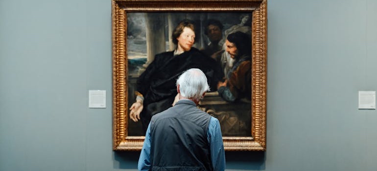 A person looking at a painting on a wall