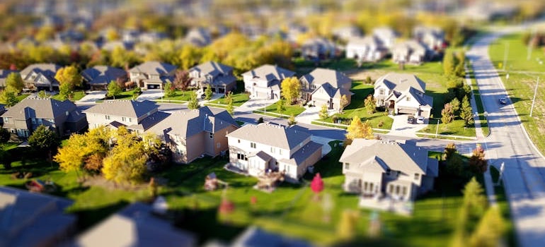 A quiet suburban street with single-family homes and lawns