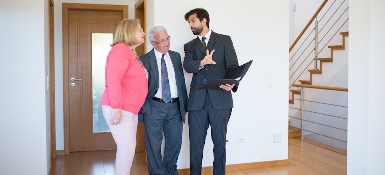 A real estate agent showing a couple a home in one of the cities near Memphis for young professionals