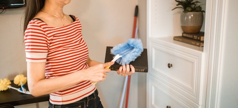 A person dusting a book