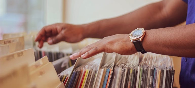 A person flipping through a collection of vinyl records
