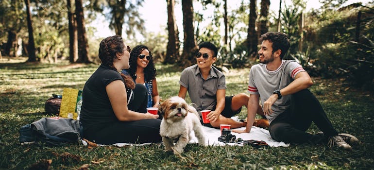 A group of friends relaxing together on the grass in a city park