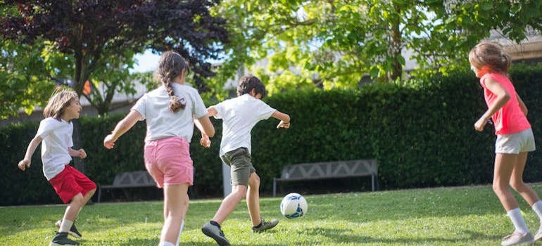 Kids playing at a park near their new school