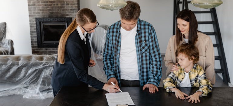 A real estate agent showing clients a home in one of the top Tennessee lake towns that offer affordable living