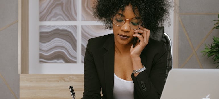 A parent making a phone call to the new school district