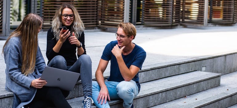 Students sitting on the steps of a university