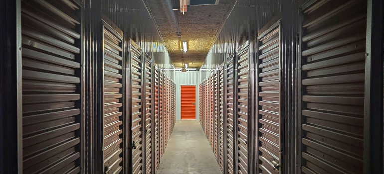 A hallway of storage units with closed doors