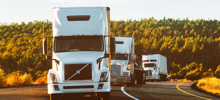 Trucks driving on a mountain highway during a Colorado move