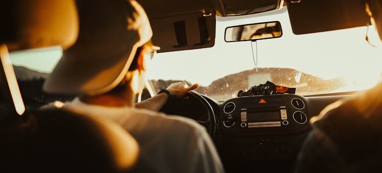 A person driving a car on a winter road trip