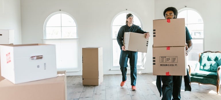 Movers carrying moving boxes