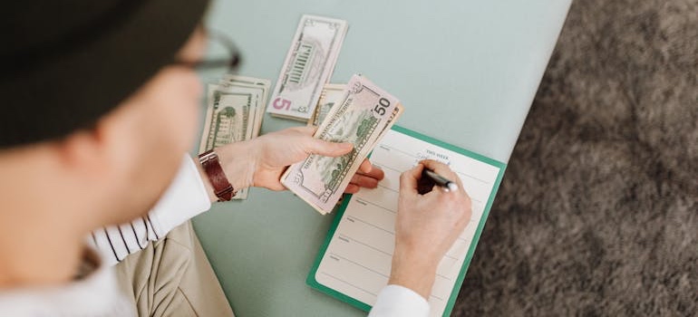 A person budgeting to move to one of the best places in Tennessee for a fresh start after a divorce