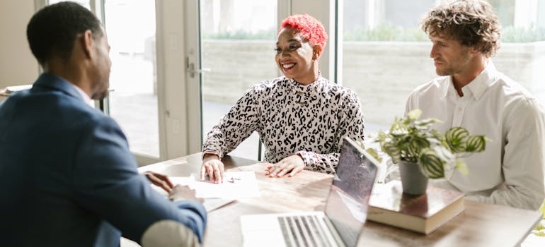 A tax accountant reviewing documents with two clients