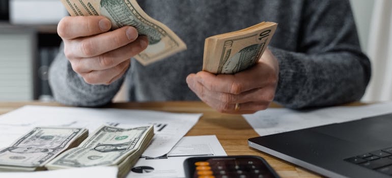 A person counting cash for a down payment