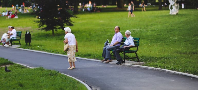 Seniors exercising together on the grass at a park