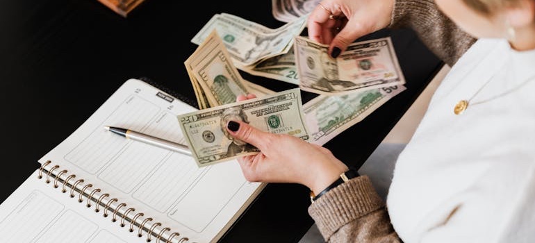 A person working through a budget with a calculator