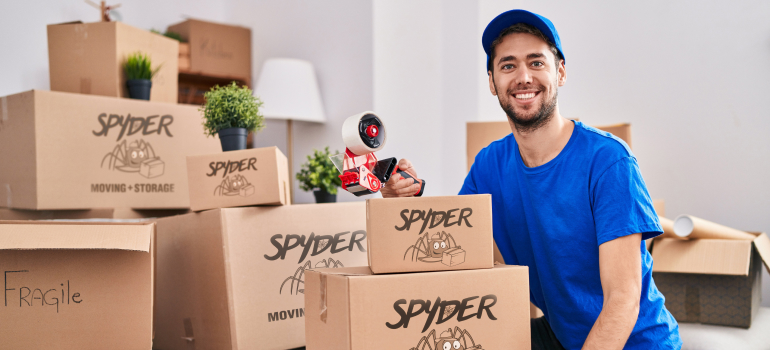 A mover who can help you with packing and moving an aquarium sitting next to moving boxes