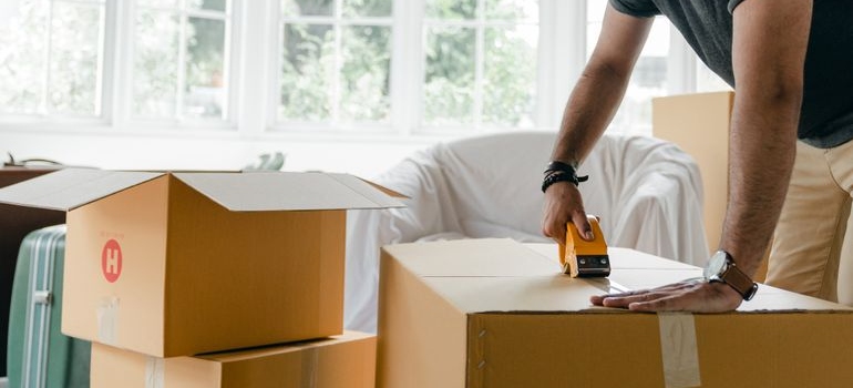 a person taping a box 