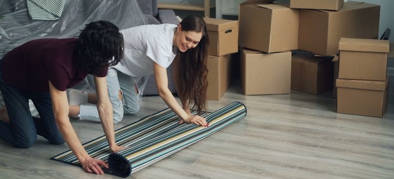 a couple rolling a rug 