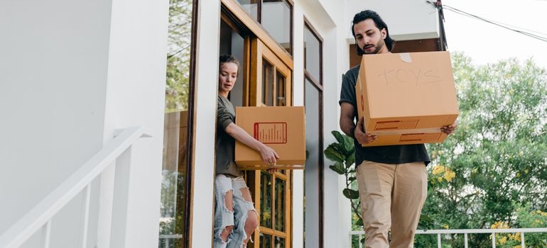 a couple with boxes moving to the suburbs in Denver